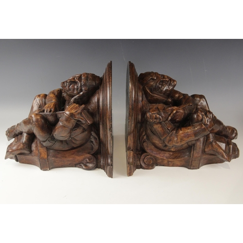 442 - A pair of walnut beam ends, in the 16th century manner, one modelled as a jester the other a musicia... 