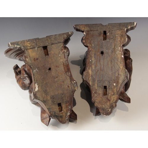 442 - A pair of walnut beam ends, in the 16th century manner, one modelled as a jester the other a musicia... 