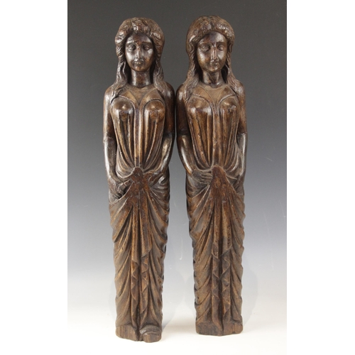 443 - A pair of carved oak figures, each modelled as a robed female with flowing hair, in the 16th century... 