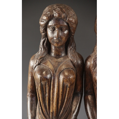 443 - A pair of carved oak figures, each modelled as a robed female with flowing hair, in the 16th century... 