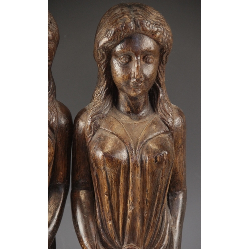 443 - A pair of carved oak figures, each modelled as a robed female with flowing hair, in the 16th century... 