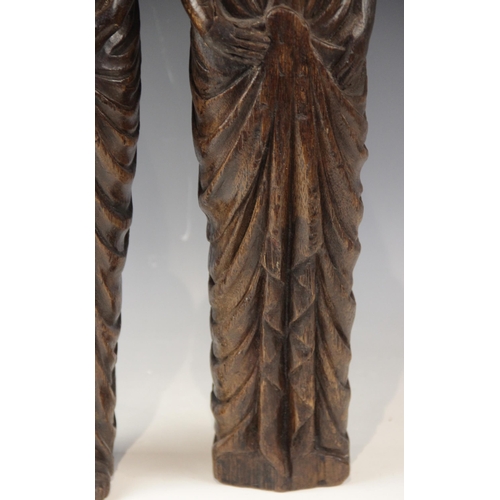 443 - A pair of carved oak figures, each modelled as a robed female with flowing hair, in the 16th century... 