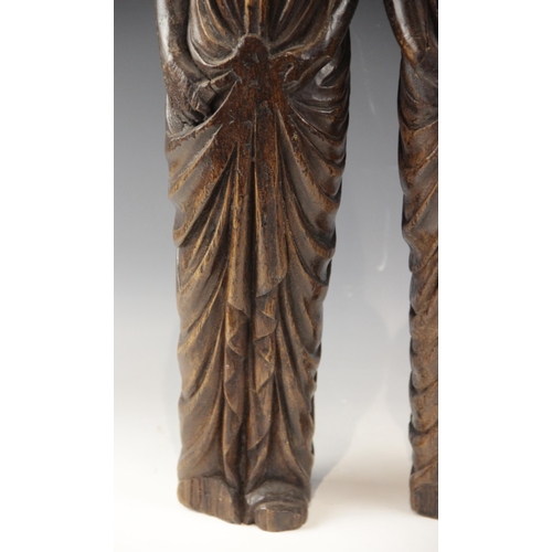 443 - A pair of carved oak figures, each modelled as a robed female with flowing hair, in the 16th century... 