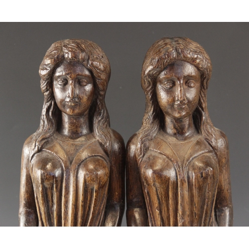 443 - A pair of carved oak figures, each modelled as a robed female with flowing hair, in the 16th century... 