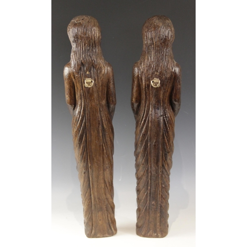 443 - A pair of carved oak figures, each modelled as a robed female with flowing hair, in the 16th century... 