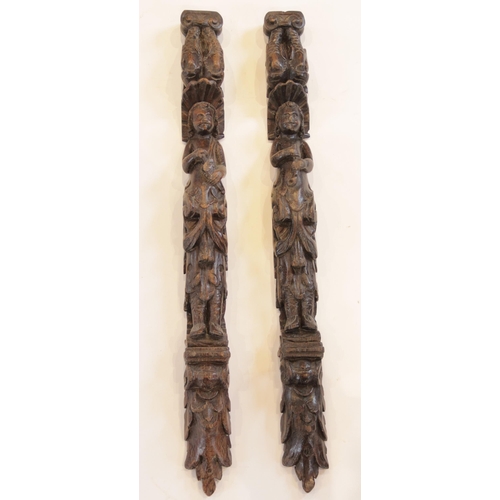 445 - A pair of carved oak pilasters, Flemish, each designed with a figure topped with paired dolphins, 10... 