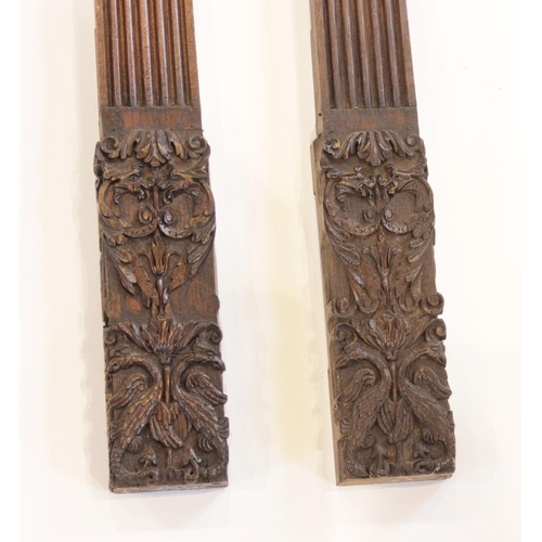 446 - A pair of oak pilasters, with leafy Corinthian and serpent carved capital, reeded pillar and leafy a... 