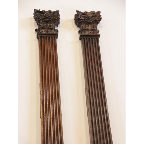 446 - A pair of oak pilasters, with leafy Corinthian and serpent carved capital, reeded pillar and leafy a... 