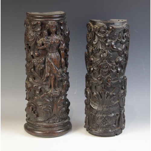 447 - Two 17th century carved oak pillar sections, each carved with scrolling foliage, one with a cherub, ... 