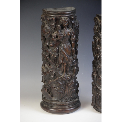 447 - Two 17th century carved oak pillar sections, each carved with scrolling foliage, one with a cherub, ... 