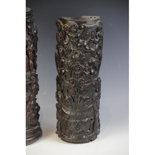 447 - Two 17th century carved oak pillar sections, each carved with scrolling foliage, one with a cherub, ... 