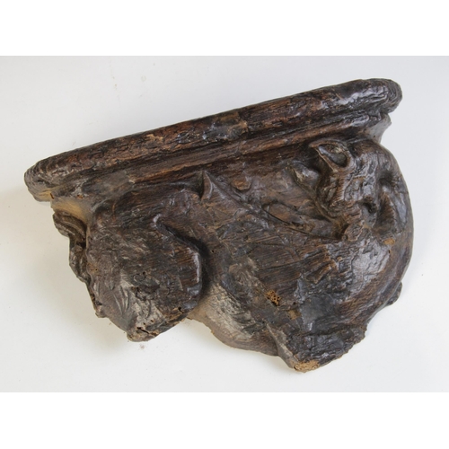 450 - A late 15th century carved oak misericord section, designed as a dragon, circa 1480, 20.5cm high x 2... 