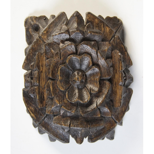 451 - A small carved oak roof boss, centred by a Tudor rose, 14cm x 11.5cm