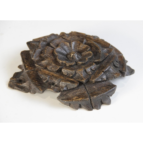 451 - A small carved oak roof boss, centred by a Tudor rose, 14cm x 11.5cm