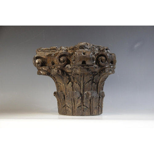 452 - A 16th/17th century carved oak Corinthian column capital, 25.5cm high, with a walnut cherub carved c... 