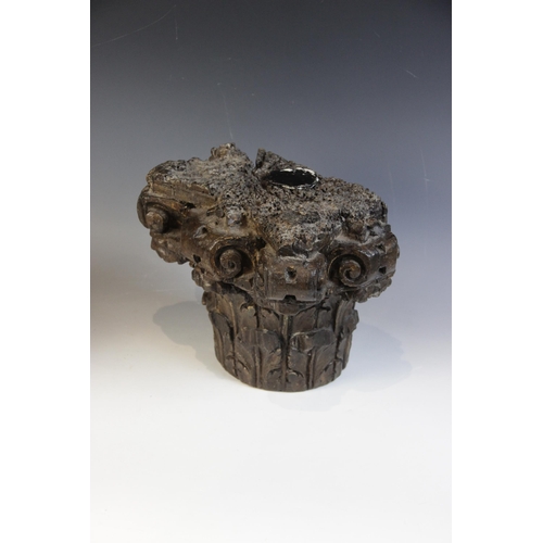 452 - A 16th/17th century carved oak Corinthian column capital, 25.5cm high, with a walnut cherub carved c... 