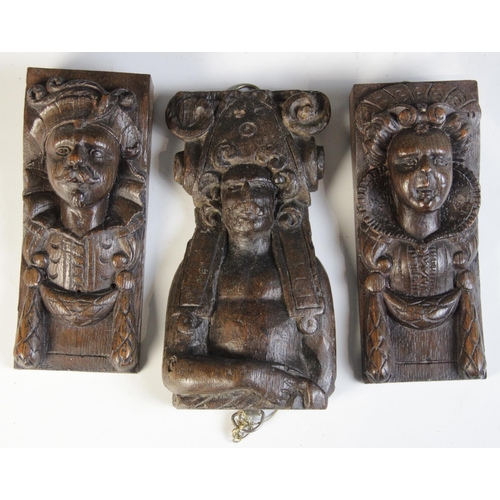 458 - A group of seven oak figural corbels, including a pair of male masks with plumed headdress 20cm high... 