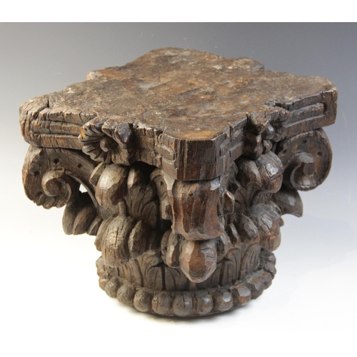 484 - A 16th century carved oak column capital, of square section and leaf carved, 27cm high x 28cm x 28cm