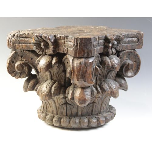 484 - A 16th century carved oak column capital, of square section and leaf carved, 27cm high x 28cm x 28cm