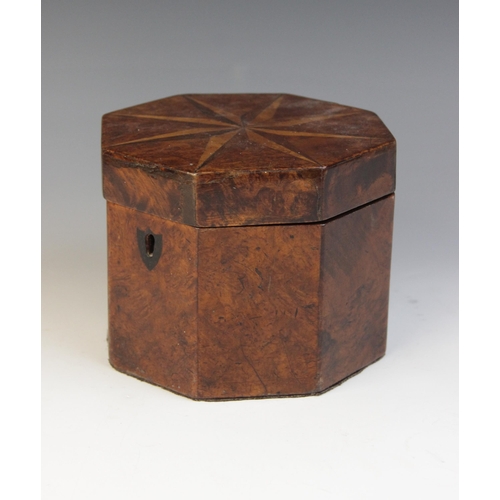 493 - A George III burr yew wood octagonal tea caddy, the hinged cover inlaid with star detail, opening to... 