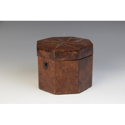 493 - A George III burr yew wood octagonal tea caddy, the hinged cover inlaid with star detail, opening to... 