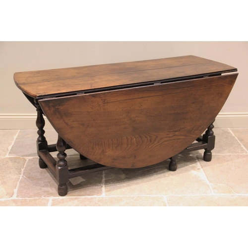 518 - * An early 18th century oak gateleg dining table, the oval table top raised upon baluster and block ... 