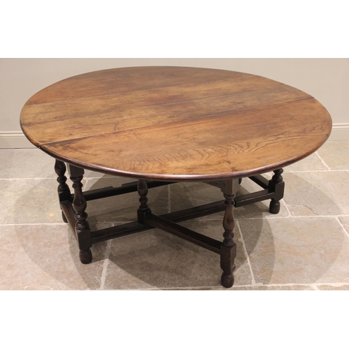 518 - * An early 18th century oak gateleg dining table, the oval table top raised upon baluster and block ... 