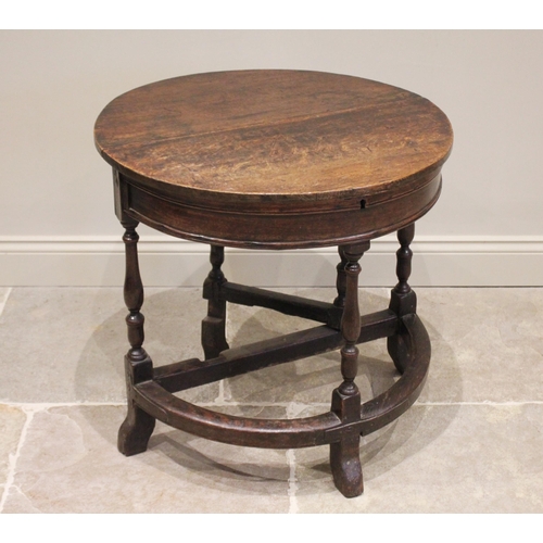 526 - A late 17th / early 18th century and later, circular oak single drop leaf table, the hinged top open... 