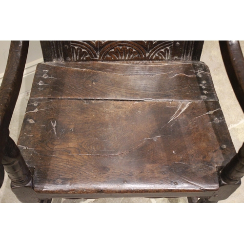 529 - A 17th century and later oak Wainscott chair, the carved leaf scrolled top rail above a back board c... 