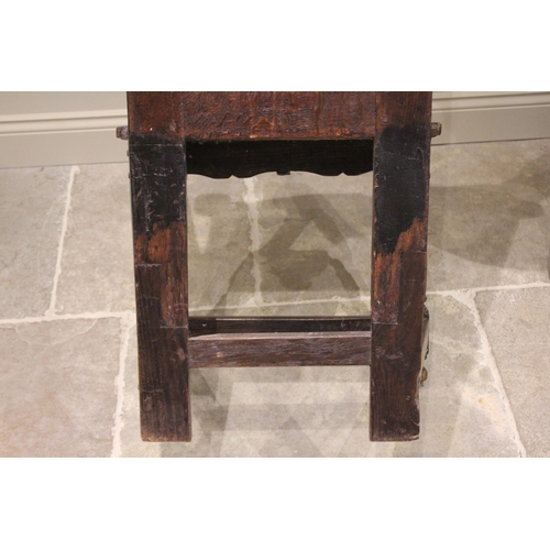 529 - A 17th century and later oak Wainscott chair, the carved leaf scrolled top rail above a back board c... 