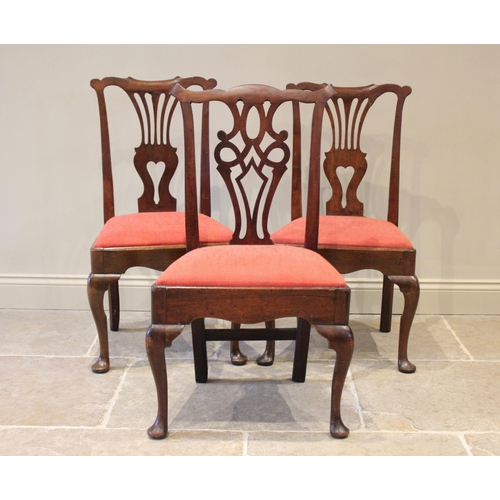 533 - A matched trio of George II/III dining chairs, each with a pierced splat back above a drop in seat a... 