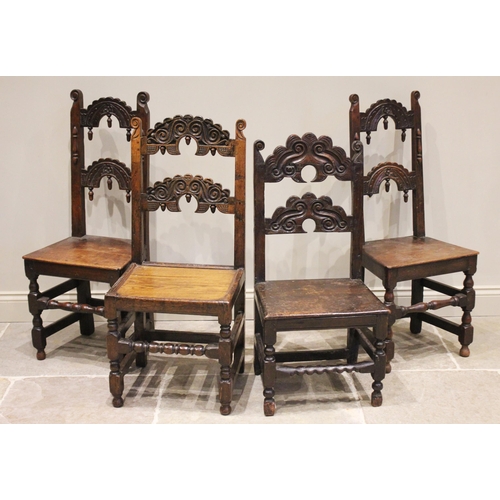 534 - A matched set of four Charles II and later oak Derbyshire chairs, each with twin crescent shaped rai... 