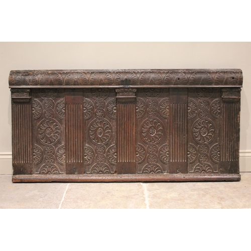 536 - A James I carved oak coffer front panel, with a lunette carved frieze over panels detailed with flow... 