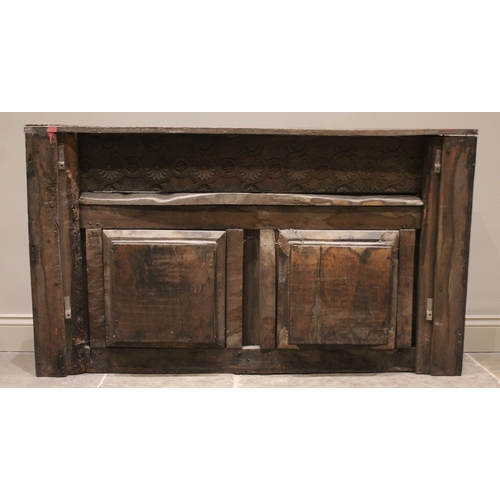 537 - An Elizabethan carved oak headboard, later converted to an overmantel, with carved roundel detail pu... 