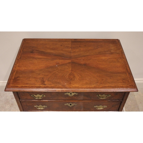 541 - An early 18th century and later, figured walnut bachelors chest, the rectangular quarter veneered an... 