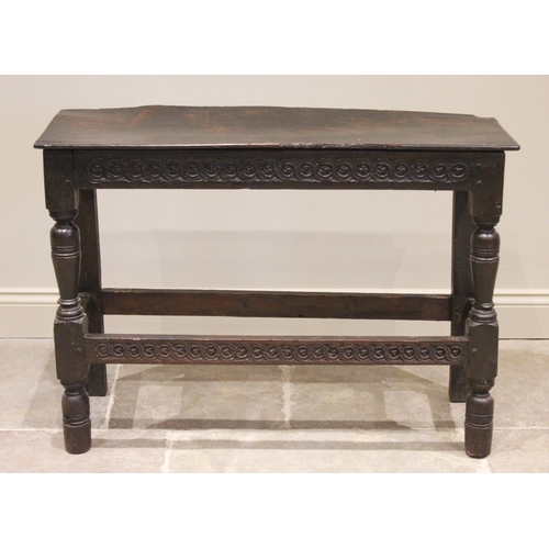 543 - A 16th/17th century and later constructed oak side table, the board top above a frieze carved with a... 