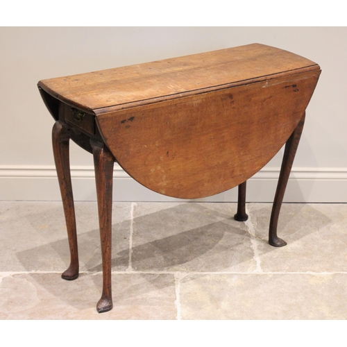 544 - A George II oak drop leaf table, the oval top above a single frieze drawer, raised upon slender cabr... 