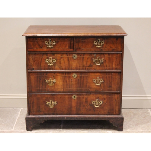 546 - An early 18th century figured walnut chest of drawers, the rectangular top above two short and three... 