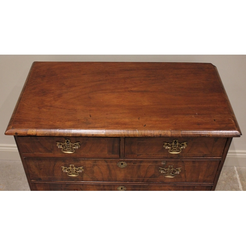 546 - An early 18th century figured walnut chest of drawers, the rectangular top above two short and three... 