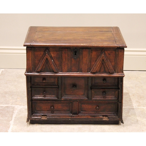 549 - A 17th/18th century oak table top cabinet. the hinged top opening to a vacant interior above a friez... 