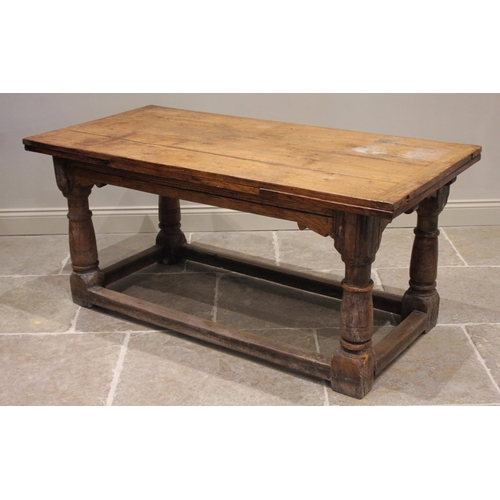 553 - A 17th century and later oak draw leaf refectory type table, the later rectangular cleated top and d... 