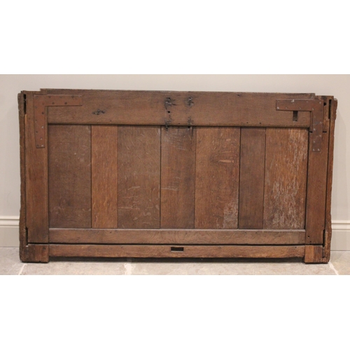 554 - A 16th/17th century oak coffer front panel, possibly French, applied with an iron lock plate above f... 