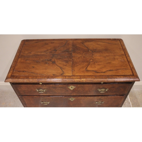 558 - An early 18th century and later figured walnut chest of drawers, the rectangular quarter veneered an... 