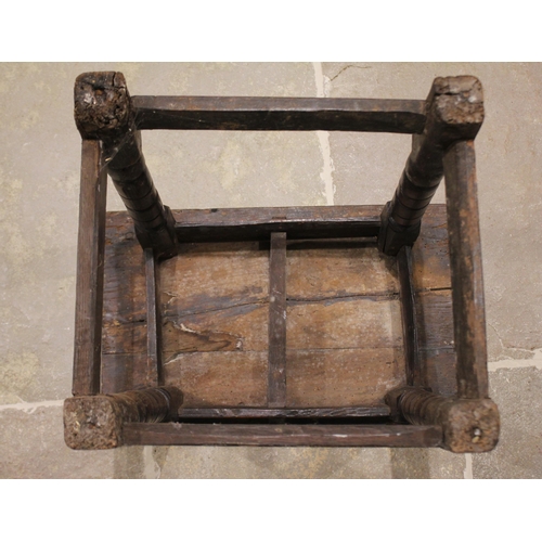 562 - An 18th century oak joint stool, the rectangular moulded top raised raised upon turned tapering and ... 