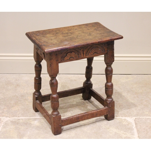 563 - An 18th century and later oak joint stool, the rectangular top with a moulded edge over a lunette ca... 