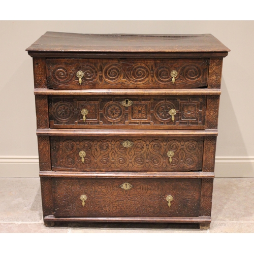 568 - A carved oak chest of drawers, 17th century and later constructed, the three board top with incised ... 