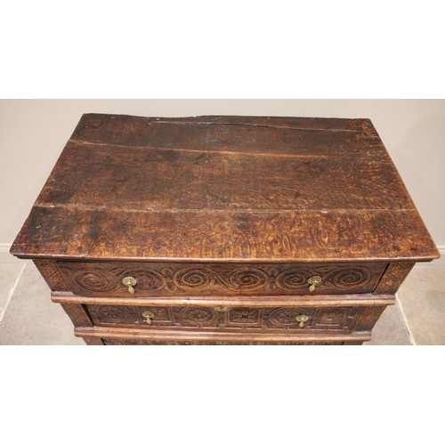 568 - A carved oak chest of drawers, 17th century and later constructed, the three board top with incised ... 