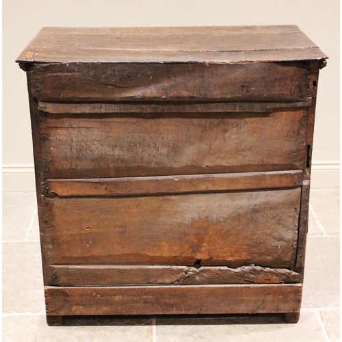 568 - A carved oak chest of drawers, 17th century and later constructed, the three board top with incised ... 