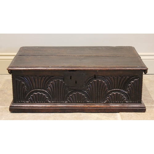 570 - A 17th century oak bible box, the twin board top with moulded rim, above a front panel carved with l... 