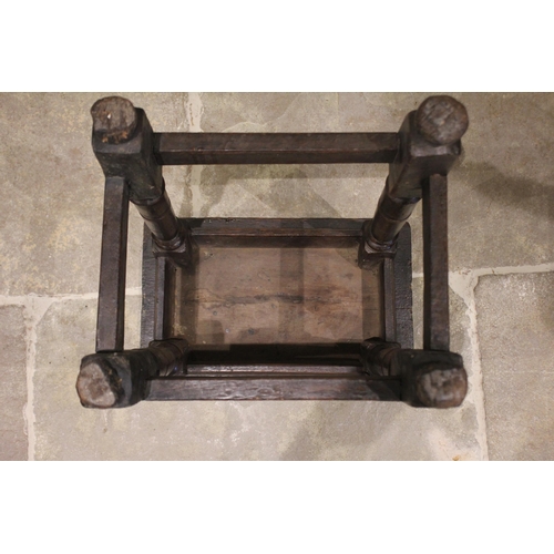 572 - An 18th century oak joint stool, the rectangular top with moulded rim raised upon ring incised legs ... 